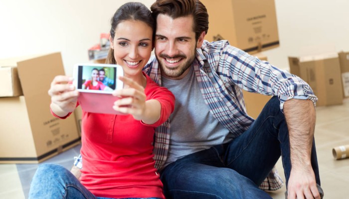 Couple in new home taking selfie