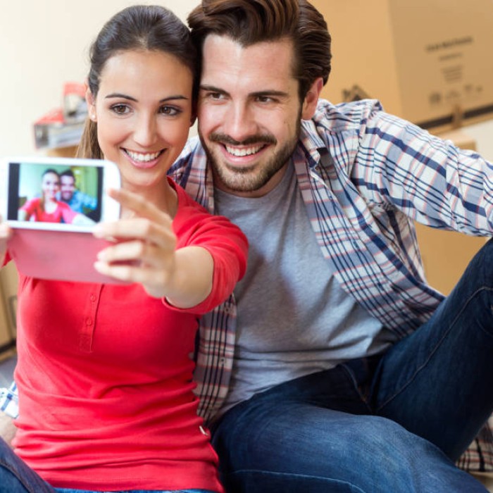 Couple in new home taking selfie